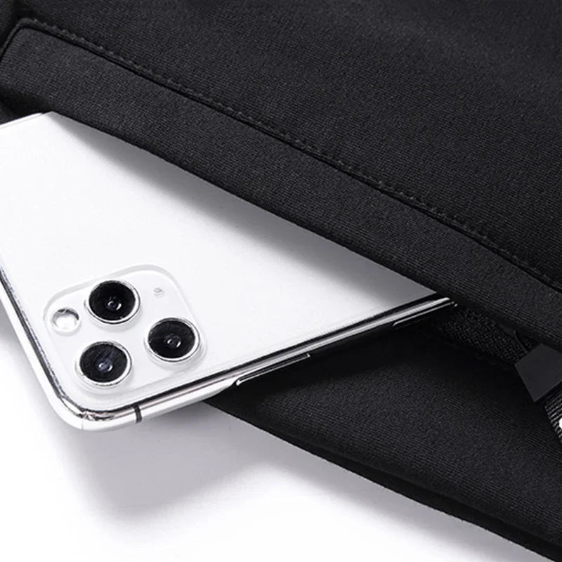 Close-up of a smartphone with a black case on a white surface