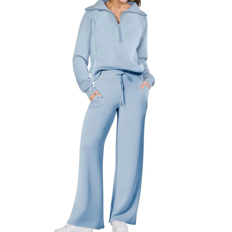 Light blue tracksuit worn by a person on a white background