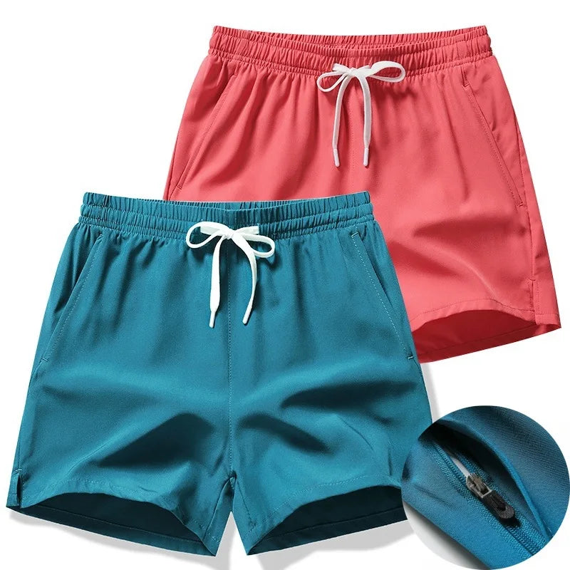 Two pairs of shorts, one red and one blue, with a blue bag on a white background.