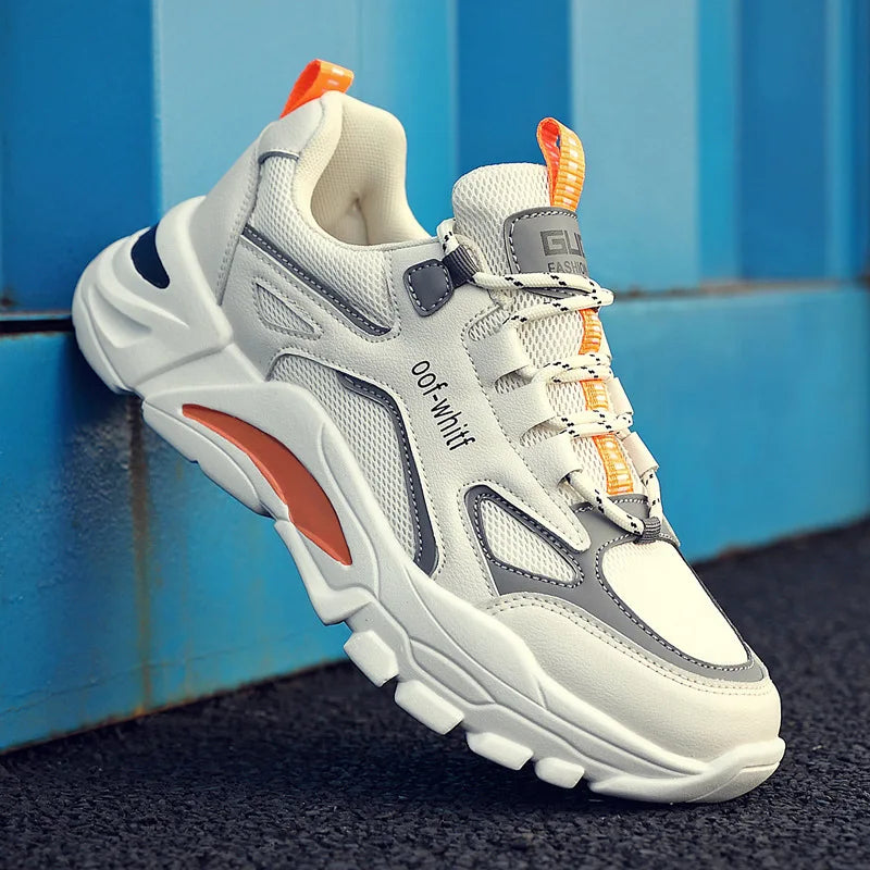 White and gray sneaker with orange accents on a blue background
