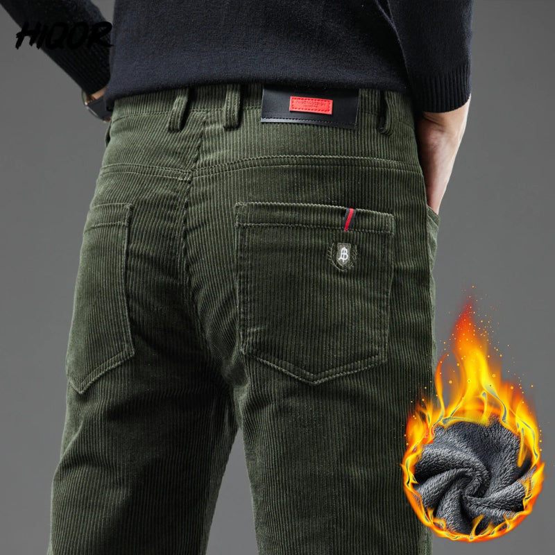 Green corduroy pants with a flame graphic and brand logo on a gray background