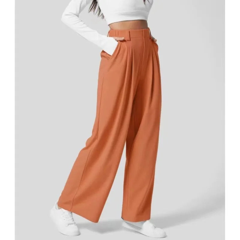 Orange wide-leg pants worn by a person on a white background