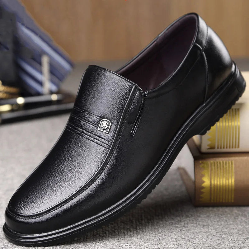 Black leather shoe on a textured surface with a blurred background