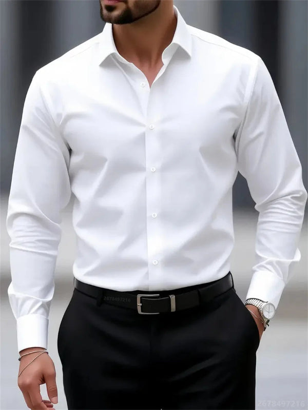Man wearing a white dress shirt and black pants against a neutral background