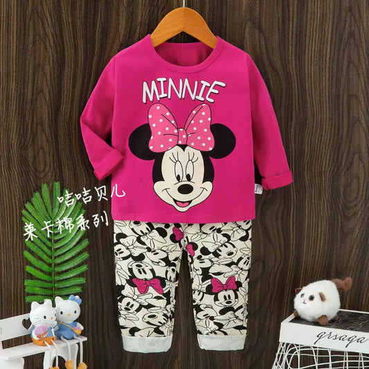 Children's outfit with Minnie Mouse design on a wooden background