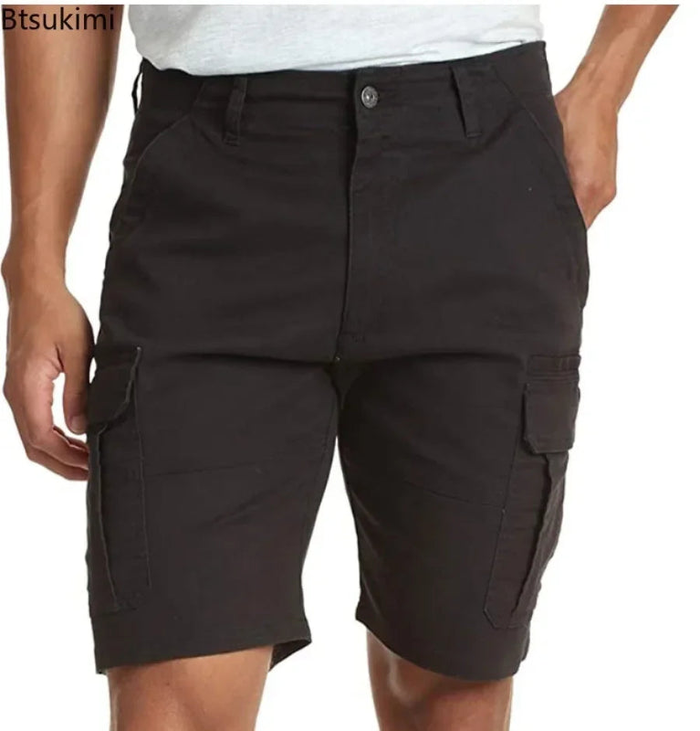 Black cargo shorts worn by a person on a white background