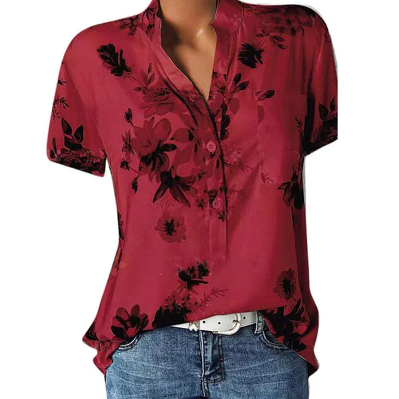 Red floral blouse with black flowers on a white background