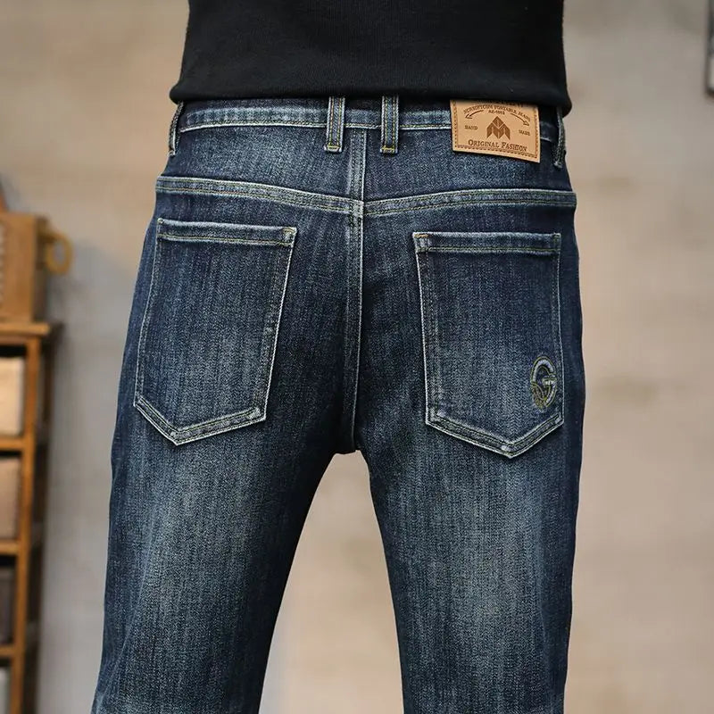 Blue jeans with a brand label on a neutral background