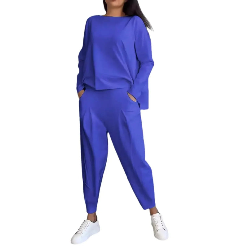 Person wearing a blue outfit with white sneakers on a white background