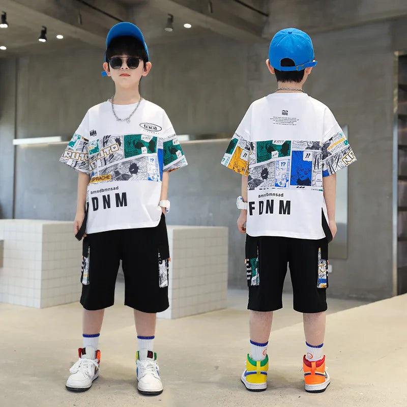 Two children wearing matching outfits with a white t-shirt and black shorts, standing in a modern indoor setting.
