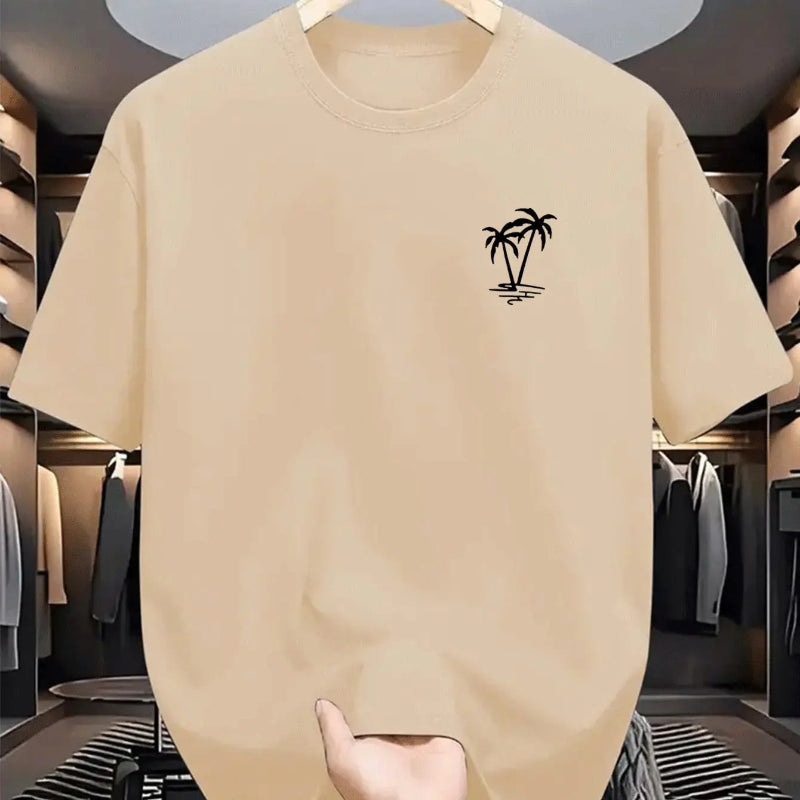 Beige t-shirt with a palm tree design on a hanger in a clothing store.