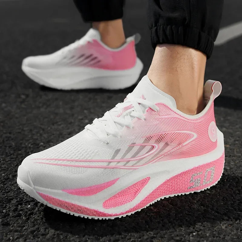 White and pink running shoes on a dark surface