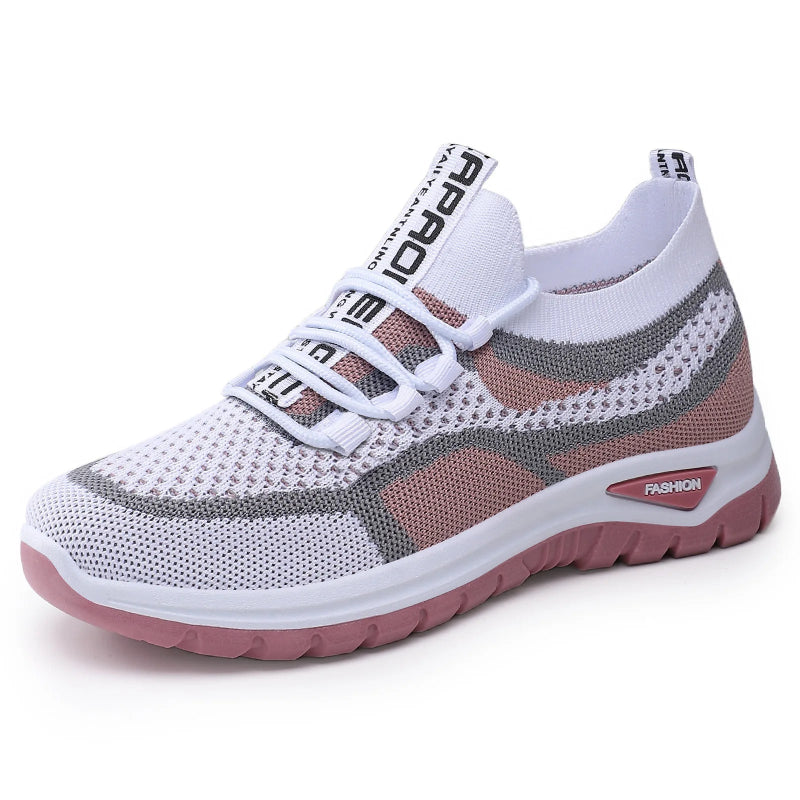 White and gray sneaker with pink sole on a white background