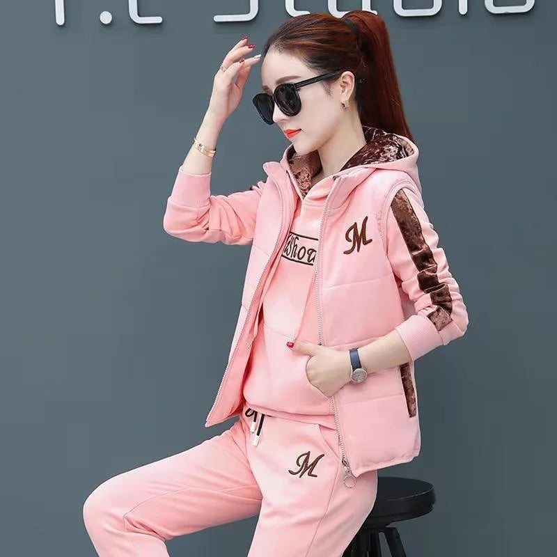 Woman wearing a pink tracksuit with a logo on a dark background