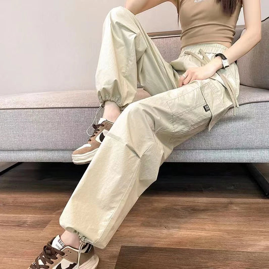 Person wearing beige cargo pants sitting on a couch.