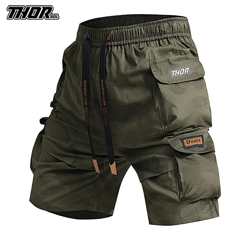 Green cargo shorts with multiple pockets and brand logos on a white background