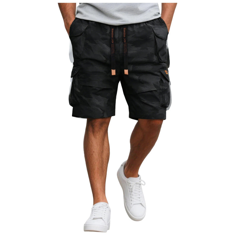 Person wearing black cargo shorts on a white background