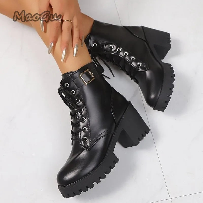 Black platform boots with a buckle on a white background