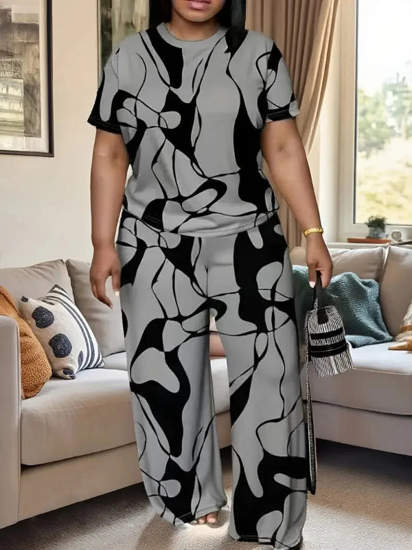 Woman wearing a black and white patterned outfit in a living room.
