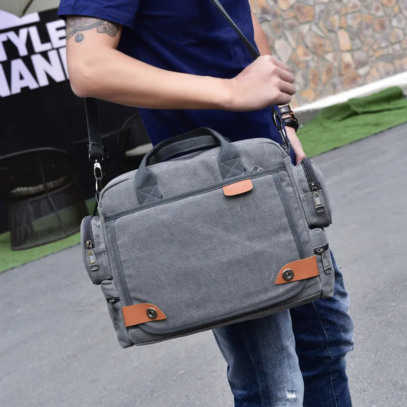 Person holding a gray bag with brown accents outdoors