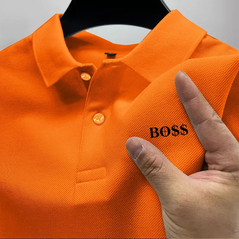 Orange polo shirt with 'BOSS' logo held by a hand on a gray background