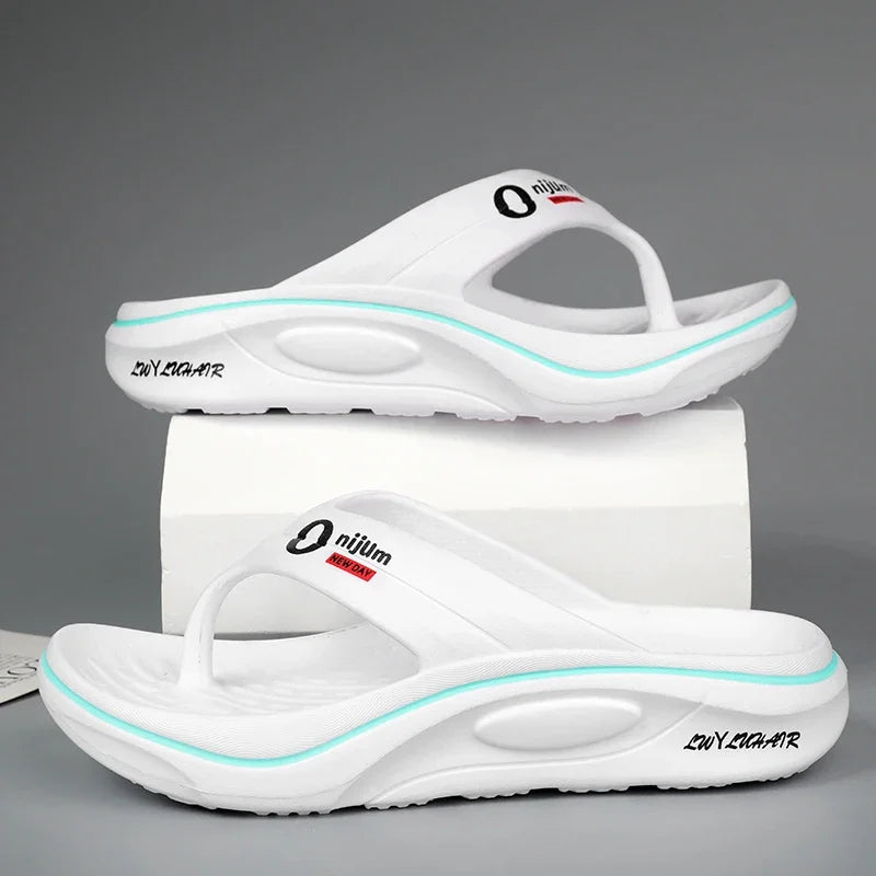White sandals with a brand logo on a gray background