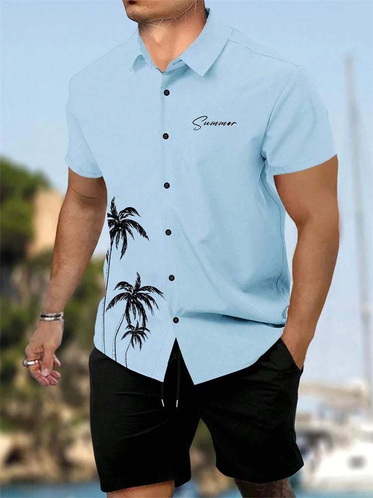 Man wearing a light blue shirt with palm tree design and 'Summer' text, standing outdoors.