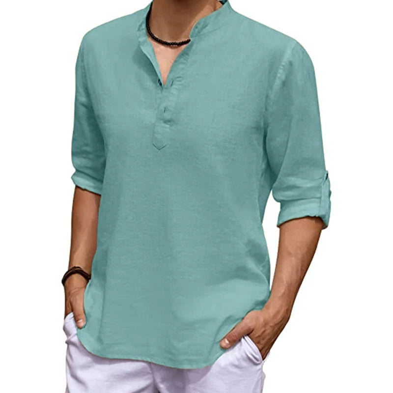 Person wearing a light green long-sleeve shirt with rolled-up sleeves on a white background
