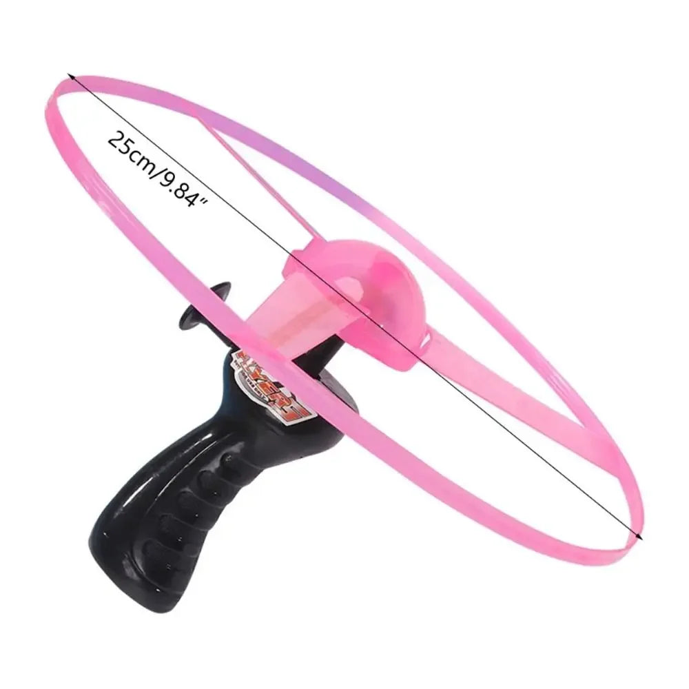 Pink ring launcher with black handle on a white background