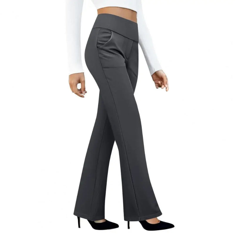 Gray flared pants worn by a person on a white background