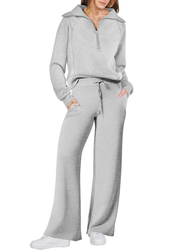 Gray tracksuit worn by a person on a white background