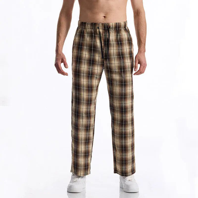 Man wearing plaid pajama pants on a white background