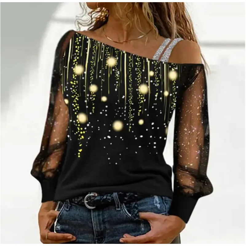 Black off-shoulder top with starry design worn by a person, on a white background