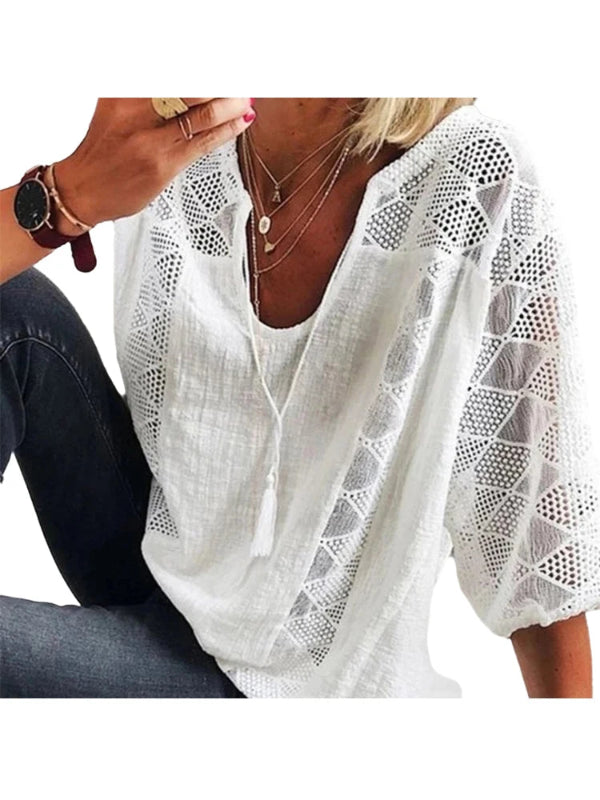 White lace blouse worn by a person on a white background