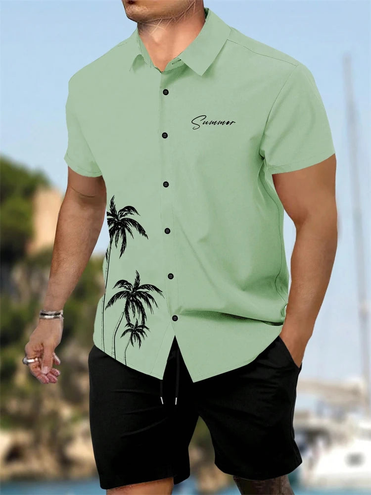 Man wearing a light green shirt with palm tree design and 'Summer' text, standing by a waterfront.