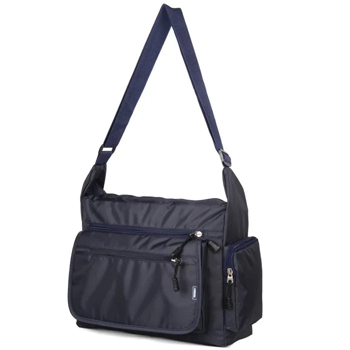 Navy blue shoulder bag with multiple zippers on a white background