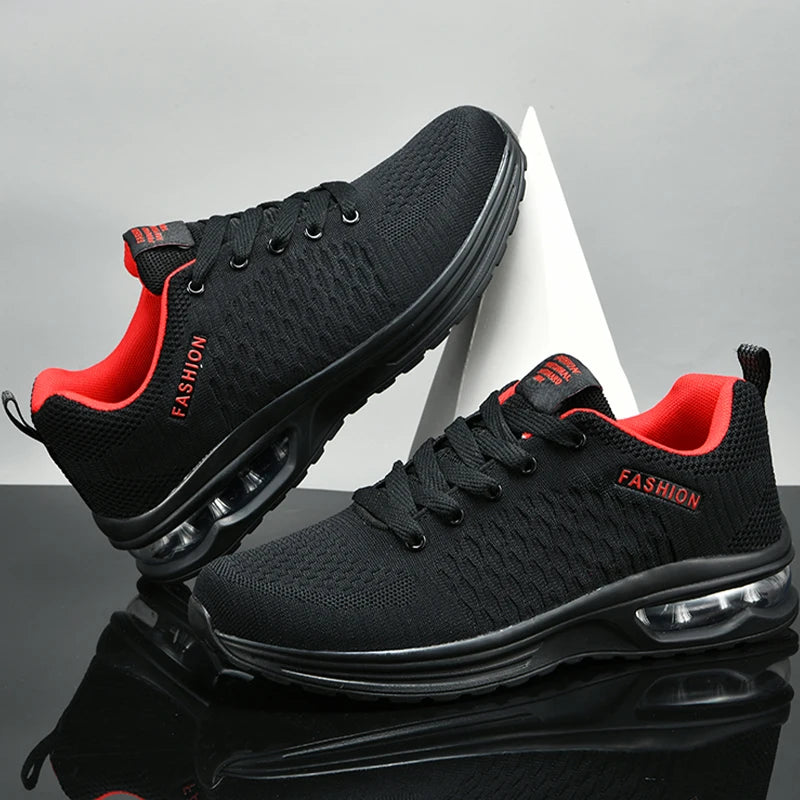 Black running shoes with red lining on a reflective surface and gray background