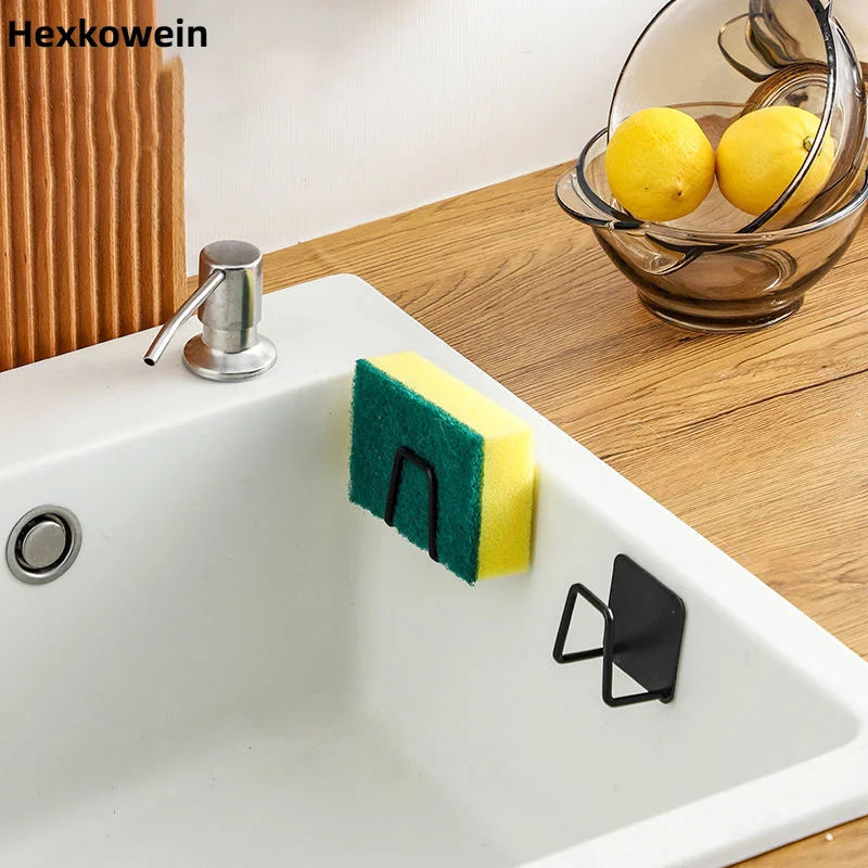 Stainless steel sponge holder mounted inside a kitchen sink holding sponge and brush with water draining 5