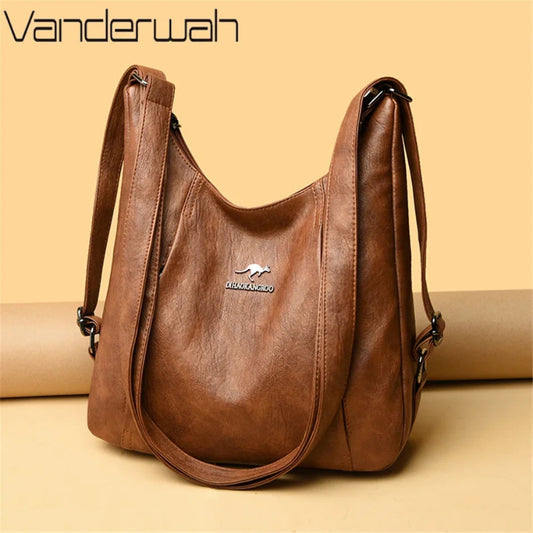 Brown leather handbag with visible brand logo on a beige background