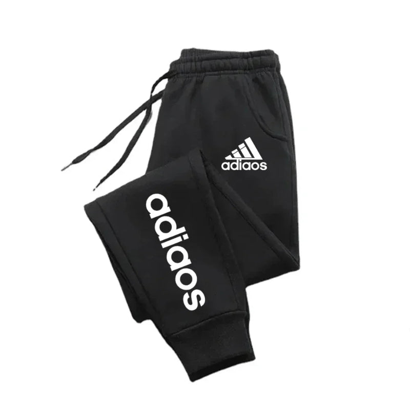 Black Adidas tracksuit on a white background