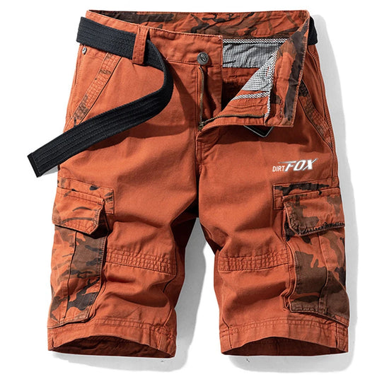 Orange cargo shorts with camouflage patterns and 'Dirt Fox' branding on a white background
