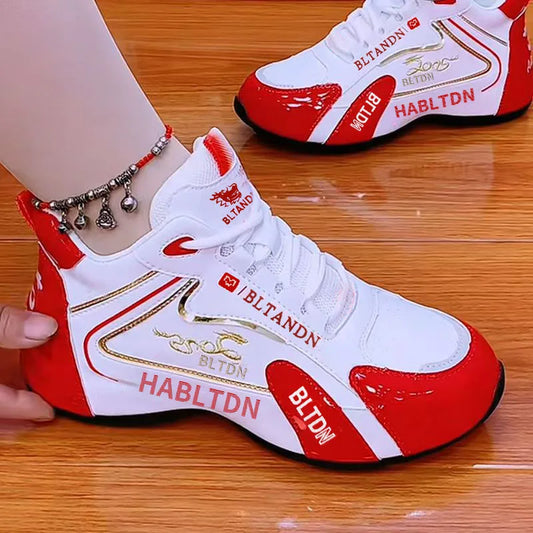 Red and white sneakers with branding on a wooden floor