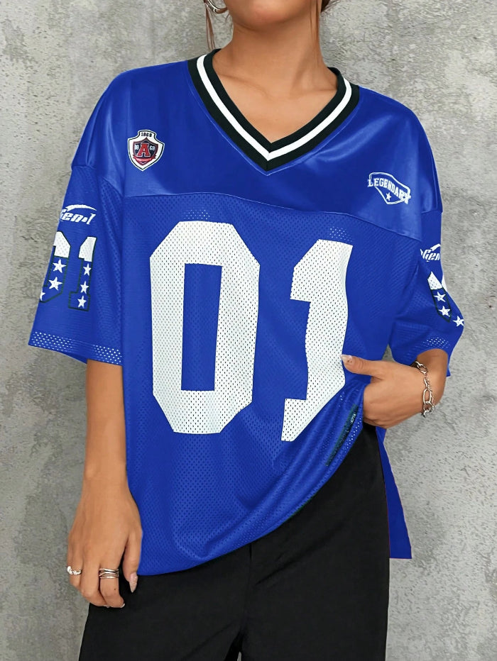 A woman wearing a black V-neck sports jersey with the number '01' on it. The jersey has white text and trim, and it appears to be made of polyester fabric.