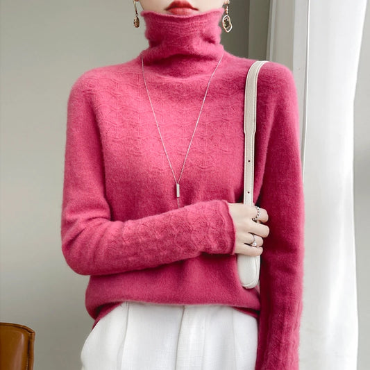 Person wearing a bright pink turtleneck sweater holding a white bag indoors.