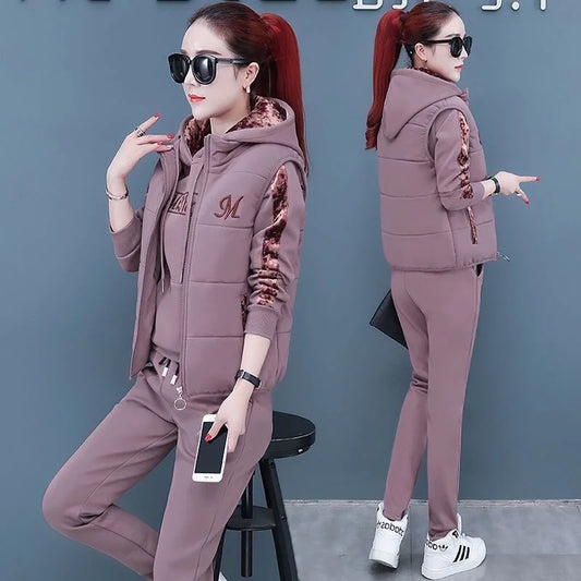 Woman in a matching tracksuit with floral details on a gray background
