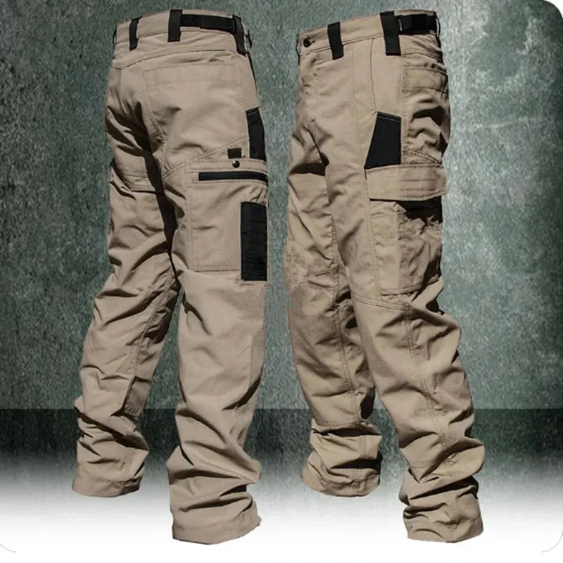 Beige tactical pants with black accents on a textured gray background