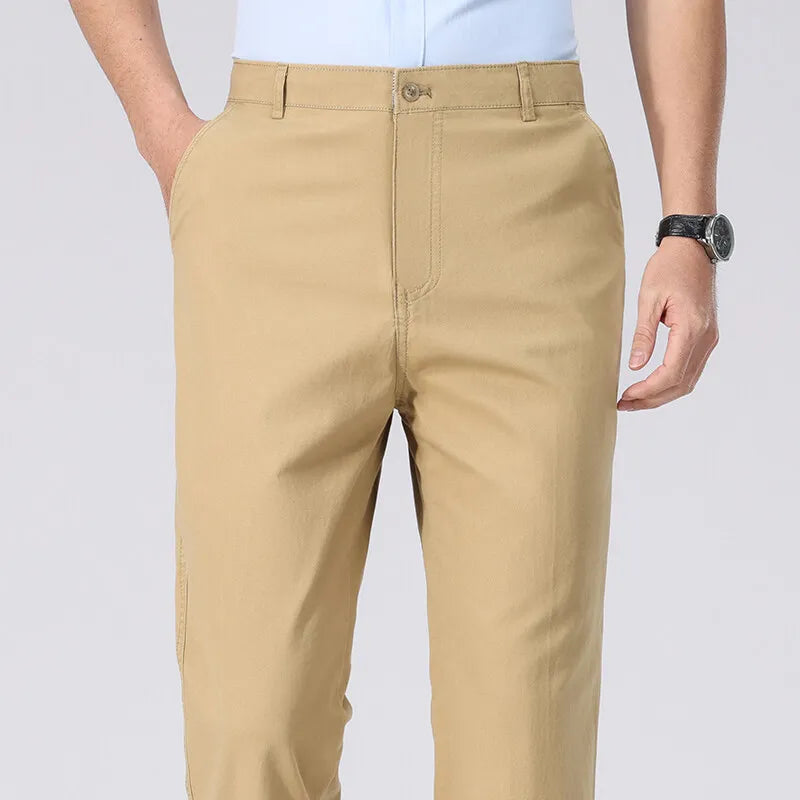 Beige pants worn by a person on a plain background