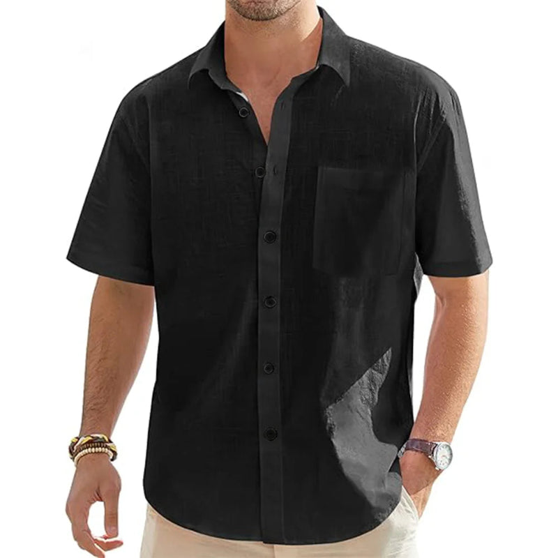 Black short-sleeve shirt worn by a person on a white background