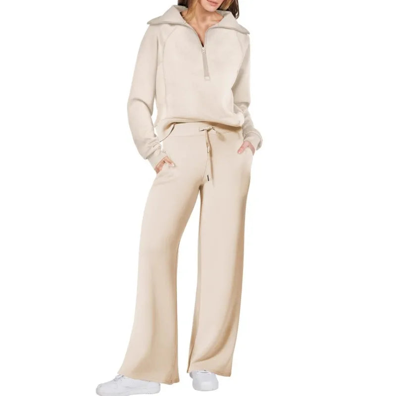 Person wearing a beige tracksuit on a white background