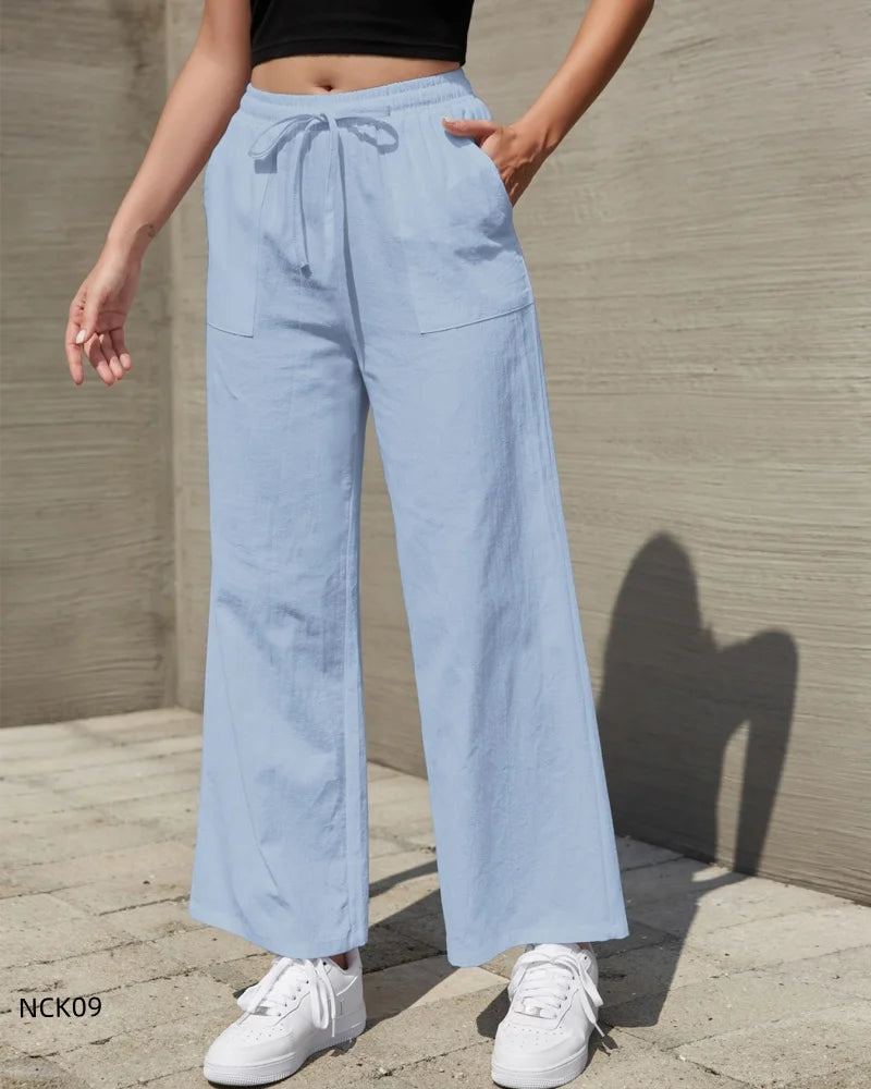 Light blue wide-leg pants worn by a person against a neutral wall.